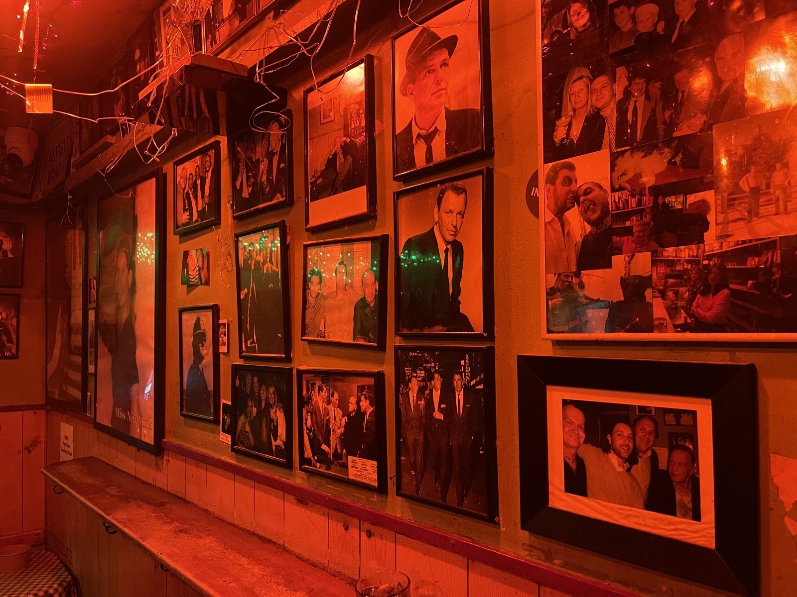 The red-lit photograph wall